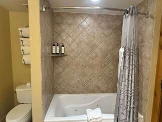 Indulge in relaxation with this luxurious jetted bathtub, perfect for unwinding after a long day.