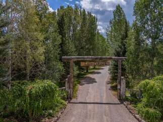 Welcome to Lazy O Ranch, a stunning property nestled amidst lush greenery and mature trees.