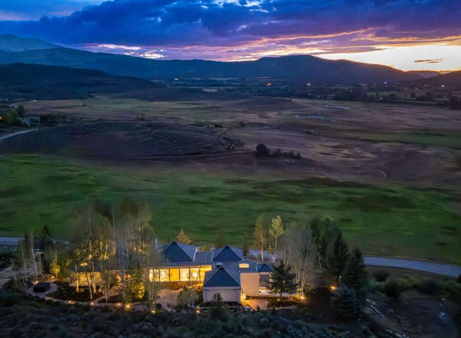 Experience luxury living in this stunning estate nestled amidst rolling hills and majestic mountains.