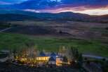 Experience luxury living in this stunning estate nestled amidst rolling hills and majestic mountains.