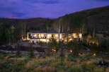 Experience luxury living in this stunning modern estate nestled against a picturesque hillside.