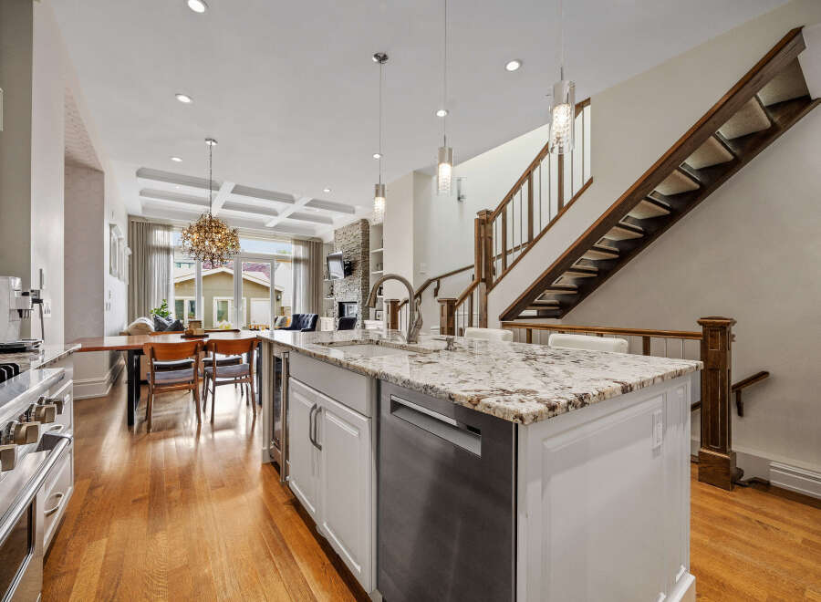 Experience luxury living in this stunning open-concept home, featuring a gourmet kitchen with a granite island and stainless steel appliances.