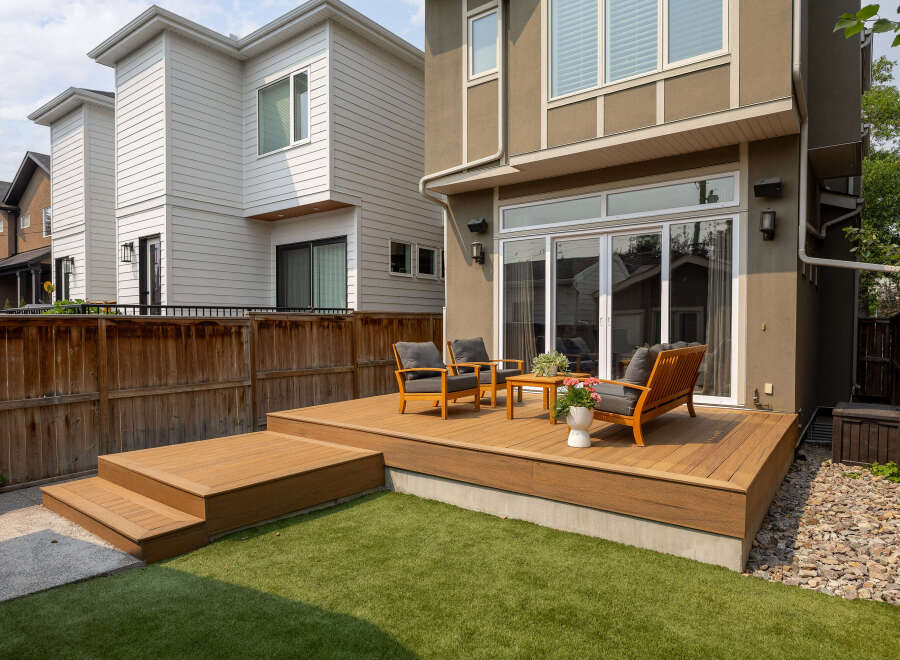 Experience seamless indoor-outdoor living with this stunning backyard oasis, featuring a spacious wooden deck perfect for entertaining.