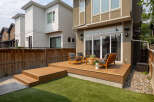 Experience seamless indoor-outdoor living with this stunning backyard oasis, featuring a spacious wooden deck perfect for entertaining.
