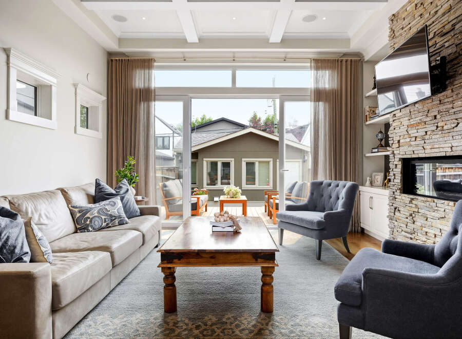 Experience seamless indoor-outdoor living with this stunning living room, featuring a large sliding glass door that opens to a charming backyard patio.