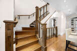 Experience elegance and craftsmanship with this stunning staircase, featuring rich hardwood treads and a sophisticated railing system.