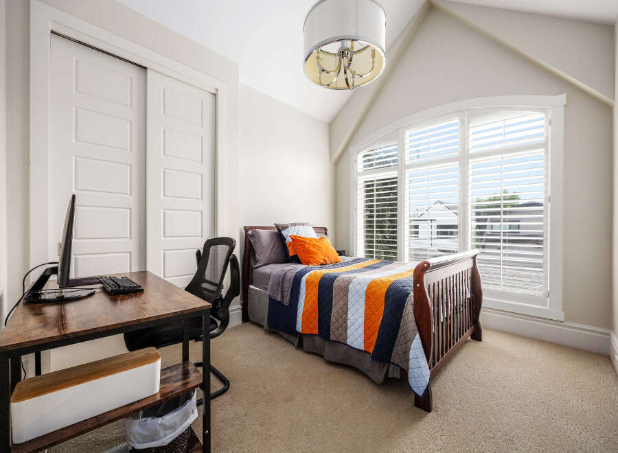 This charming bedroom features a comfortable bed with a colorful quilt, perfect for a cozy retreat.