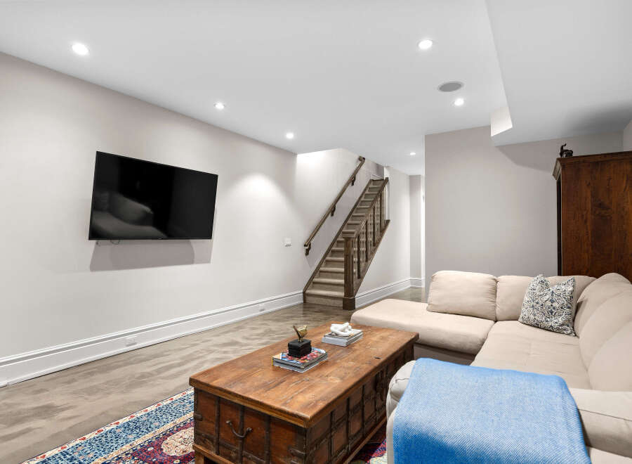 This basement living area features a large sectional sofa perfect for relaxing and entertaining.