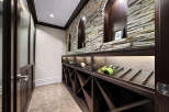 Discover this exquisite wine cellar, featuring a stunning stacked stone accent wall with arched niches, perfect for displaying your finest vintages.