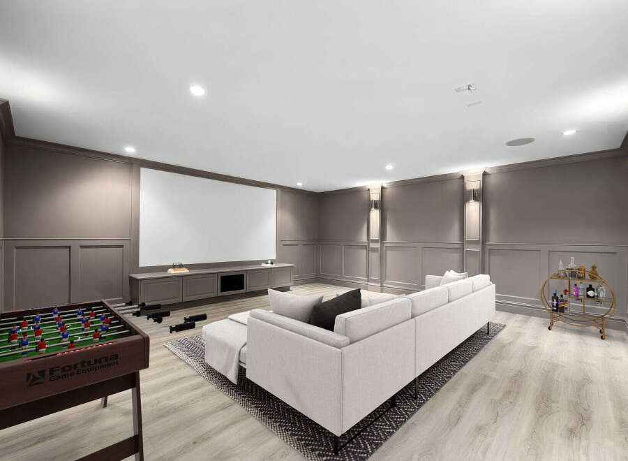 Experience ultimate entertainment in this sophisticated basement media room, featuring a large projection screen and comfortable sectional sofa.