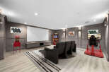 Experience ultimate entertainment in this dedicated home theater and gaming room.