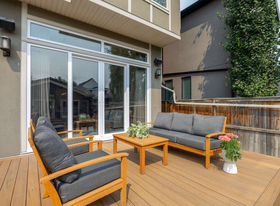 Enjoy outdoor living on this spacious wooden deck, perfect for entertaining or relaxing.