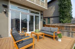 Enjoy outdoor living on this spacious wooden deck, perfect for entertaining or relaxing.