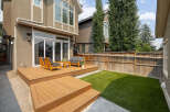 Step outside to a beautifully designed backyard featuring a multi-level wooden deck perfect for entertaining.