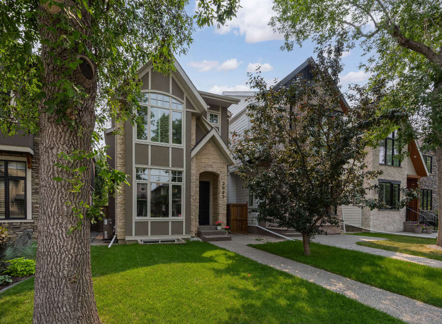 Discover modern living in this stunning multi-level home, featuring a striking stone and stucco exterior.