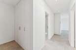 Step into this modern hallway featuring a sleek, built-in wardrobe for ample storage.