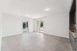 Experience modern living in this spacious, light-filled apartment featuring two sets of sliding glass doors that open onto private balconies, perfect for enjoying the outdoors.