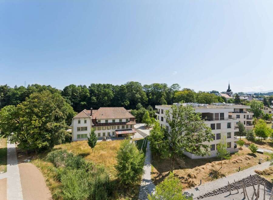 Discover modern living in this contemporary apartment complex, featuring sleek architecture and spacious balconies perfect for enjoying the serene surroundings.
