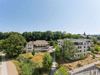 Discover modern living in this contemporary apartment complex, featuring sleek architecture and spacious balconies perfect for enjoying the serene surroundings.