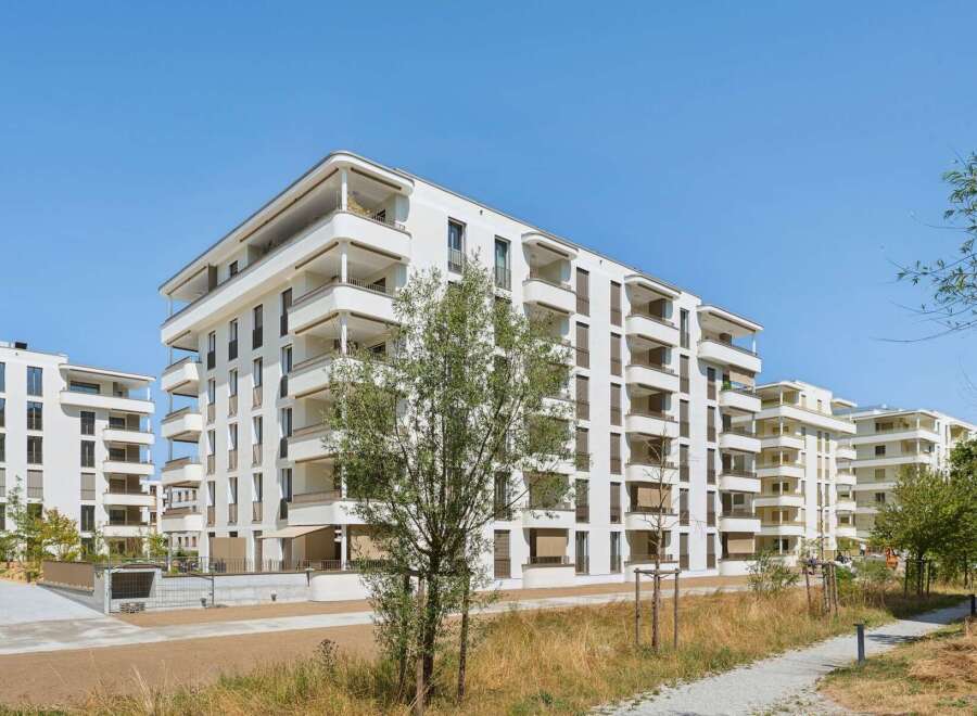 Discover modern living in this stunning new construction apartment complex, featuring sleek white exteriors and abundant private balconies.