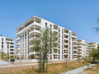Discover modern living in this stunning new construction apartment complex, featuring sleek white exteriors and abundant private balconies.