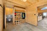 Discover this charming mountain retreat featuring a well-organized entryway with a spacious shoe rack and ample storage for outerwear.