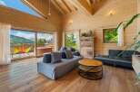 Experience breathtaking mountain views from this stunning wooden chalet living room.