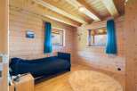Experience cozy mountain living in this charming wooden cabin bedroom.