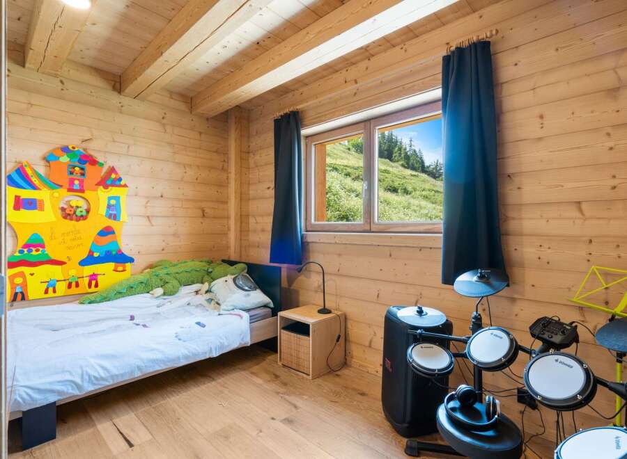 Discover this charming wooden cabin bedroom, perfect for a creative retreat.