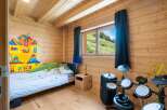 Discover this charming wooden cabin bedroom, perfect for a creative retreat.