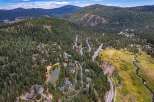 Nestled amidst a dense pine forest, this aerial view showcases a serene mountain community.