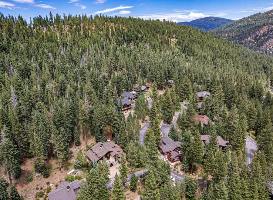Nestled amidst a dense forest of mature pine trees, this property offers a serene mountain retreat.