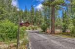 Nestled amidst towering pine trees, this stunning property offers a private oasis with a beautiful wooden home and a dedicated tennis court.