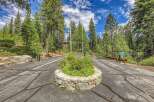 Discover the exclusive entrance to Hidden Lake, a private community nestled amidst towering pine trees.