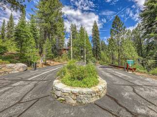 Discover the exclusive entrance to Hidden Lake, a private community nestled amidst towering pine trees.