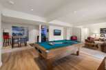 Experience ultimate entertainment in this finished basement, featuring a full-size pool table perfect for game nights.