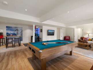 Experience ultimate entertainment in this finished basement, featuring a full-size pool table perfect for game nights.