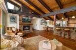 Experience rustic charm and modern comfort in this stunning living space, featuring a magnificent stone fireplace as the centerpiece.