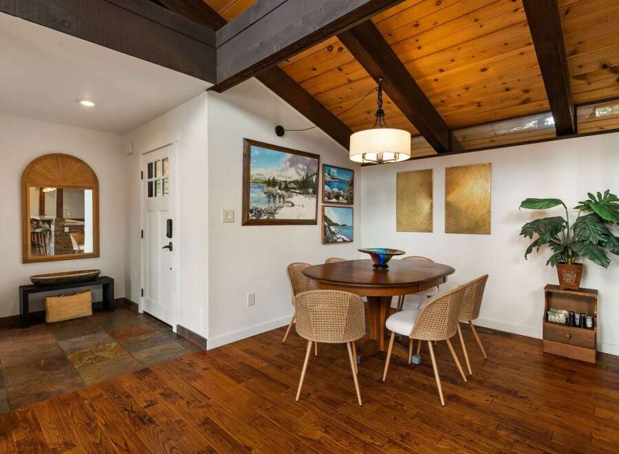 Experience rustic charm in this dining area featuring a warm wooden table and woven chairs, perfect for intimate gatherings.