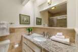 This beautifully appointed bathroom features a spacious vanity with a granite countertop and an undermount sink, perfect for your morning routine.