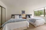 This inviting bedroom features two comfortable beds, perfect for accommodating guests or family.