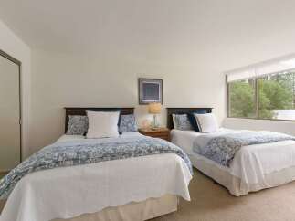 This inviting bedroom features two comfortable beds, perfect for accommodating guests or family.