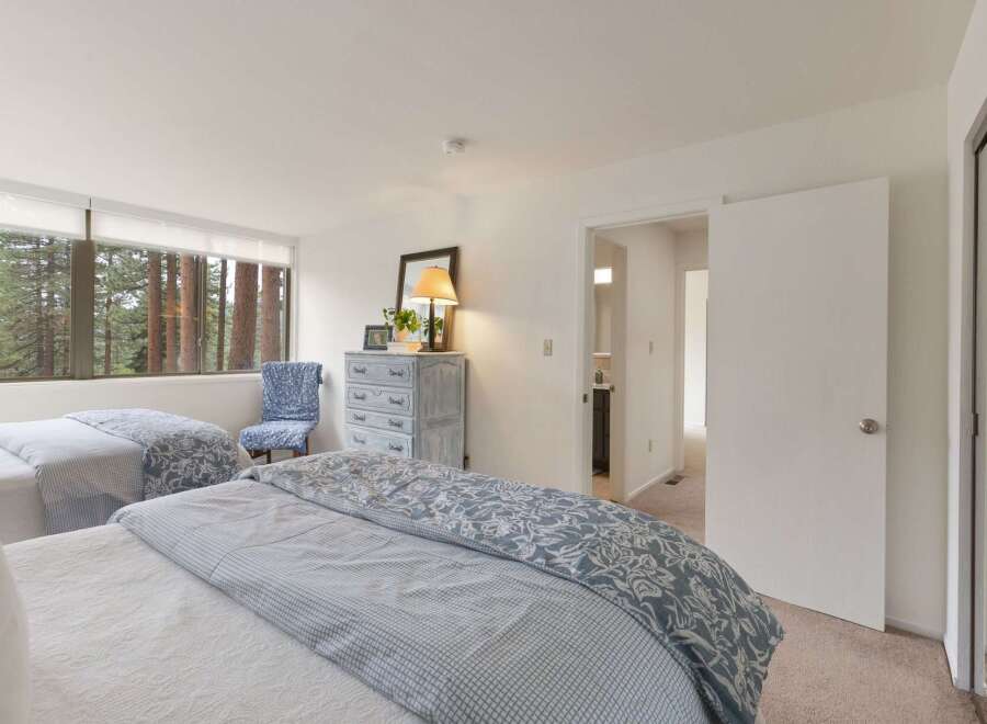 Experience serene living with this spacious bedroom featuring two comfortable beds, perfect for families or guests.