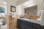 This charming bathroom features a spacious vanity with a granite countertop and a large mirror, perfect for your morning routine.