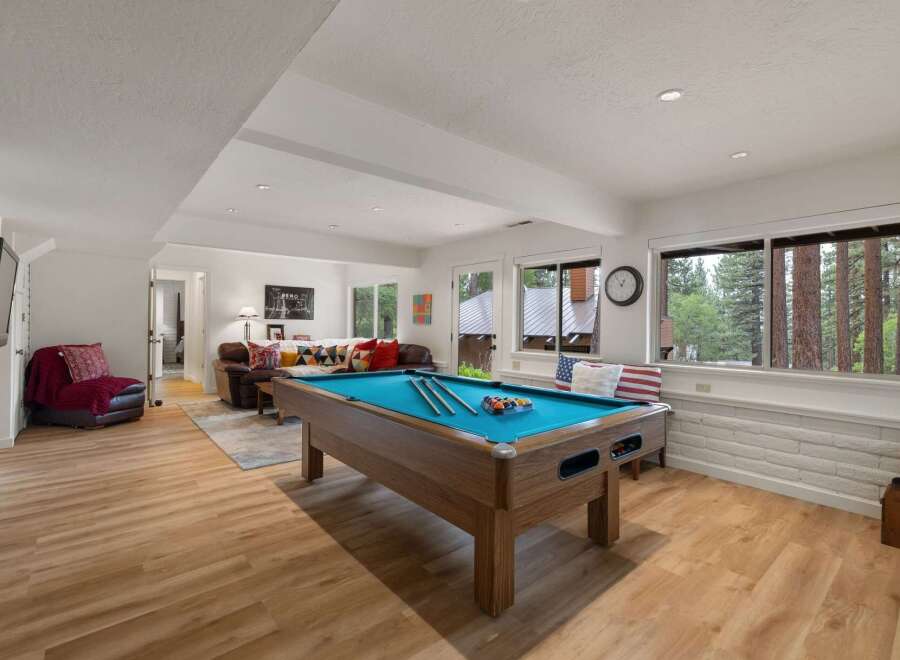 Enjoy endless entertainment in this spacious game room, featuring a professional pool table perfect for friendly competitions.