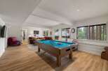 Enjoy endless entertainment in this spacious game room, featuring a professional pool table perfect for friendly competitions.