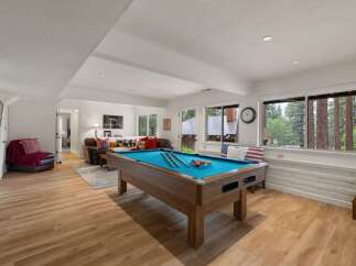 Enjoy endless entertainment in this spacious game room, featuring a professional pool table perfect for friendly competitions.