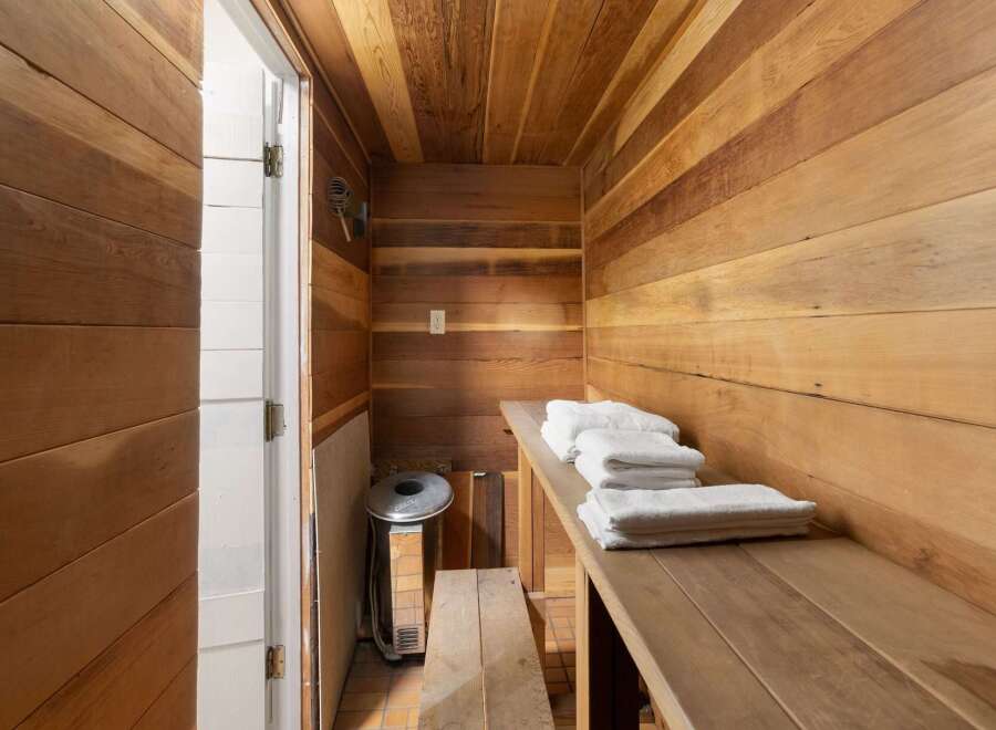 Experience ultimate relaxation in this beautifully crafted wooden sauna, featuring natural wood paneling on the walls and ceiling.