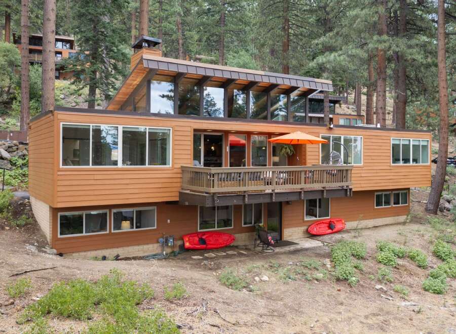 Experience modern living in this stunning multi-level home nestled among tall pine trees.