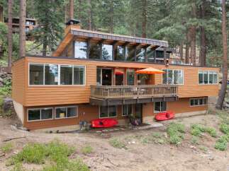 Experience modern living in this stunning multi-level home nestled among tall pine trees.